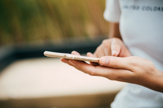 person-standing-while-using-phone-business-presence