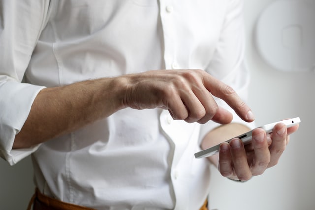 person-holding-white-smartphone-in-white-shirt