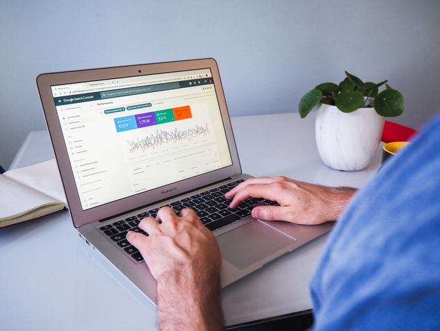  person-using-laptop-on-white-table