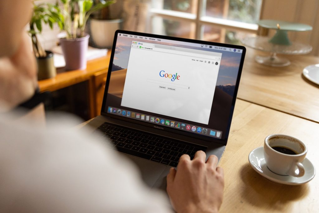 person-using-macbook-with-coffee-on-table