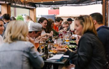 people dining on table and talking